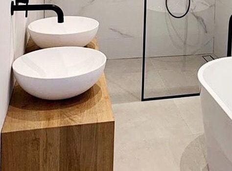 Freestanding bathtub as statement piece with floor-to-ceiling tiling - Doncaster luxury bathroom