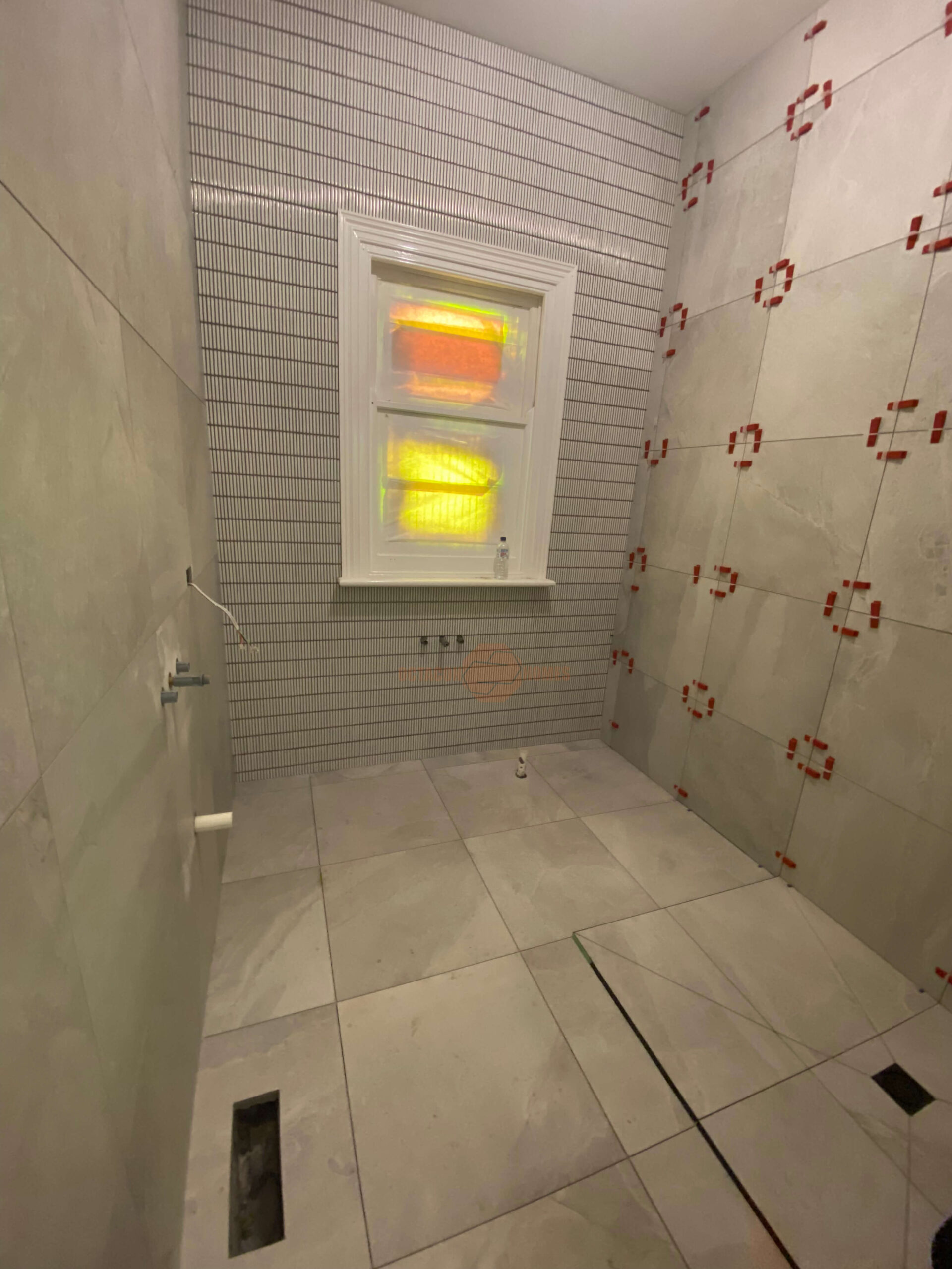 Melbourne bathroom renovation showing tiling, flooring, and plumbing work near completion