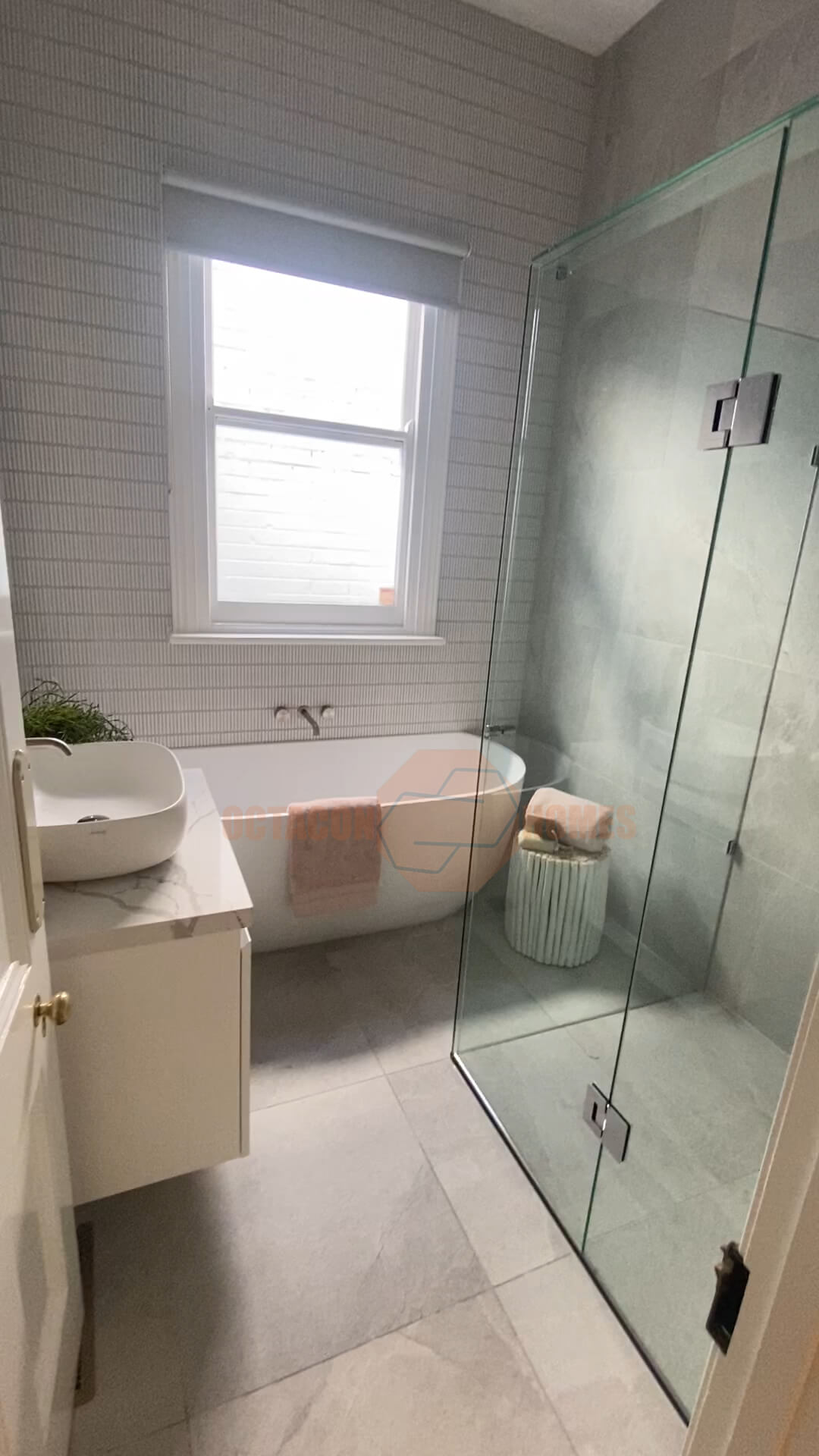 Completed Melbourne bathroom renovation featuring new sink, bath, shower, and vanity