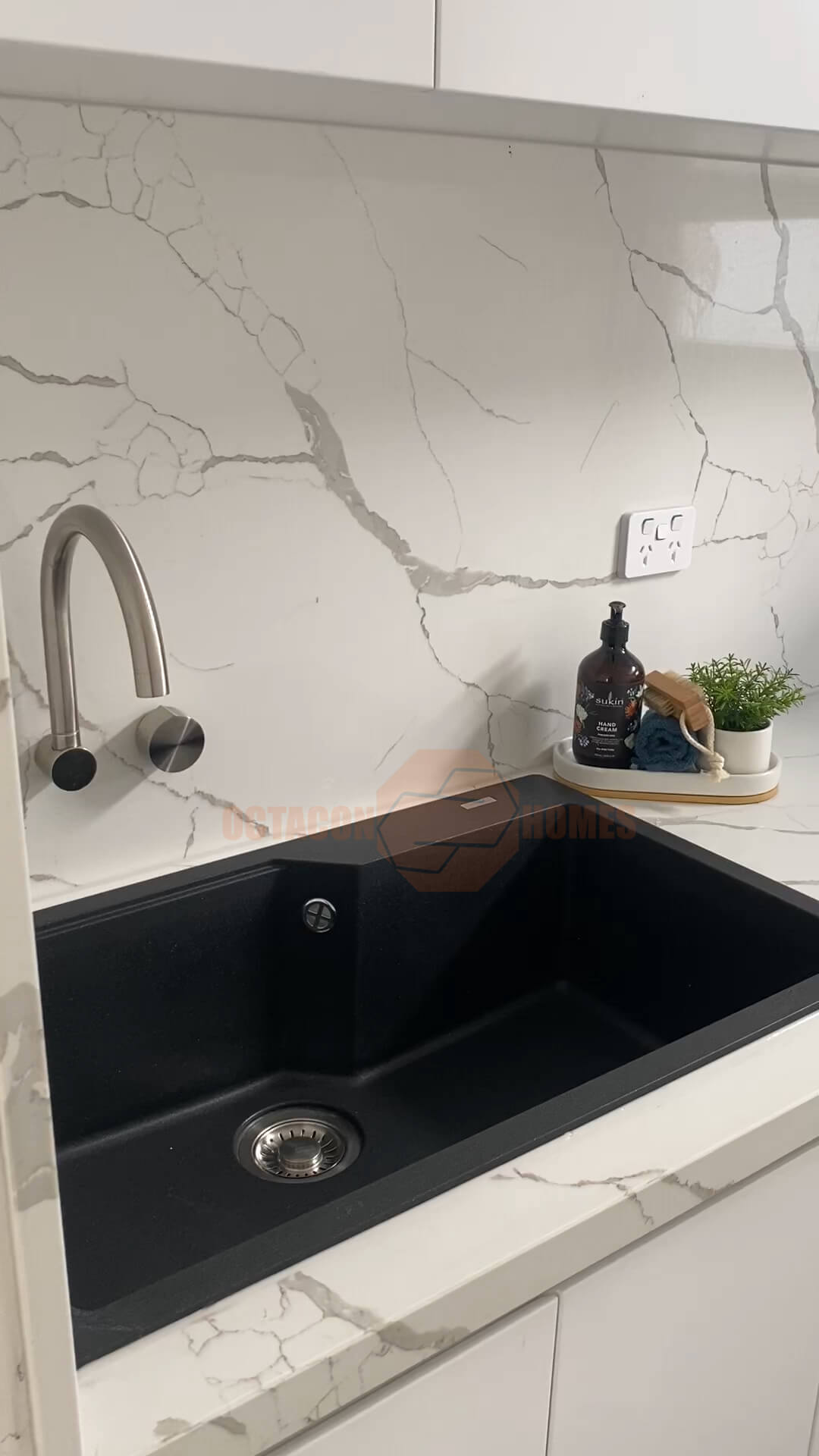 Beautiful marble ceramic splashback with black sink showing detailed craftsmanship